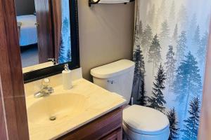a bathroom with a sink and a toilet and a shower curtain at Happy Jack in Rapid City +15 photos
