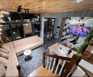 an aerial view of a living room with a couch at Rest House İsmayıllı A frame in İsmayıllı
