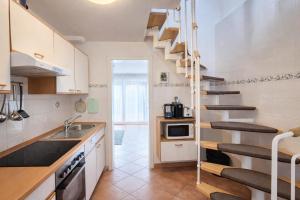 a kitchen with a spiral staircase in a apartment at Ferienhaus Klüver in Kühlungsborn