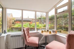a room with windows and a table and chairs at 1 Bed in Elton oc-dctco in Elton