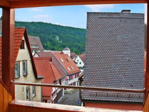 a view from a window of a town with roofs at Hotel Löwen in Blaubeuren