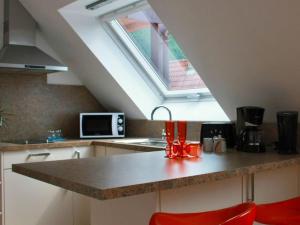 a kitchen with a counter top with a window at Hotel Löwen in Blaubeuren