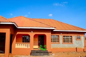 a rendering of a house with an orange roof at Kristina Gardens 1BD & Studio Homes in Voi