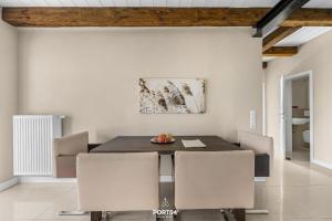 a dining room with a table and chairs at Ferienwohnung Lille Hus 1 St Peter-Ording in Böhl +30 photos