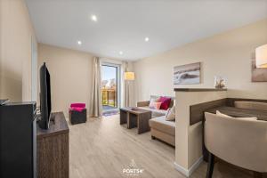 a living room with a couch and a tv at Ferienwohnung Lille Hus 3 St Peter-Ording in Böhl +29 photos