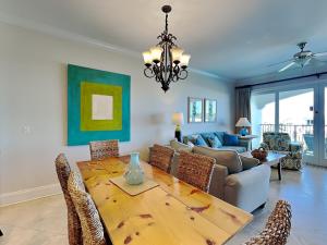 a dining room with a table and a couch at Adagio #402D in Santa Rosa Beach
