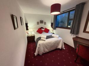 a hotel room with two beds and a window at Tullyeskar House - Monasterboice in Philipstown