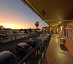 a parking lot with cars parked outside of a building at Heritage Inn - Milpitas in Milpitas