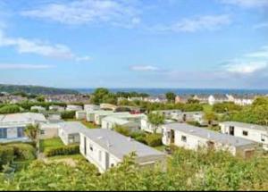 a city with white houses and the ocean in the background at 2 Vale Park in Fishguard