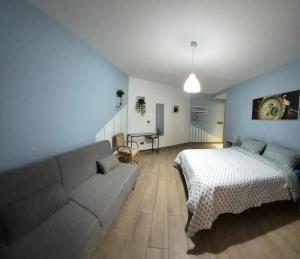 a living room with a bed and a couch at Holiopolis in St. Paul's Bay