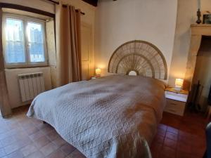 a bedroom with a large bed and a window at La Source de Romay 2 pers 5 min Paray in Volesvres