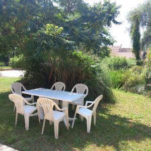 a blue table and four chairs in a yard at La Source de Romay 2 pers 5 min Paray in Volesvres +1 photo