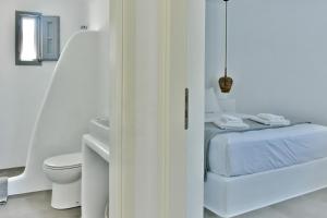 a white bedroom with a bed and a toilet at Relaxia Estate Naxos By KB Hospitality in Galini +75 photos
