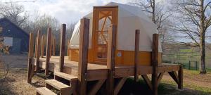 a yurt is sitting on a wooden platform at Dôme géodésique Le petit prince in Le Rousset