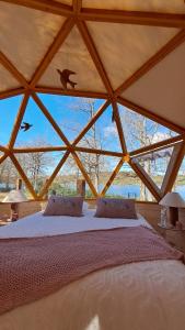a large bedroom with a bed in a tent at Dôme géodésique Le petit prince in Le Rousset