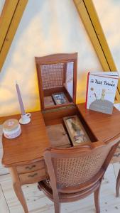 a wooden desk with a book on top of it at Dôme géodésique Le petit prince in Le Rousset