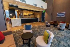 a lobby of a hotel with chairs and a bar at Hampton By Hilton Antofagasta in Antofagasta