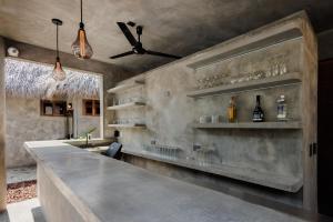 a bar with a counter with glasses on it at Hotel Boutique Pikiliki - ADULTS ONLY in Brisas de Zicatela +94 photos