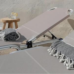 a white chair with a table next to a stool at Sunsets and Olive Trees in Messini