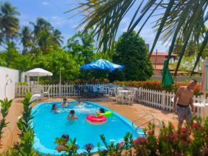 a group of people in a swimming pool at Casa de Japaratinga in Japaratinga