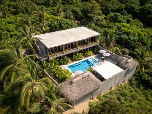 an aerial view of a house with a swimming pool at Hotel Boutique Pikiliki - ADULTS ONLY in Brisas de Zicatela