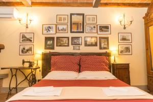 a bedroom with a bed with pictures on the wall at Podere Il Poggiolo in Rufina