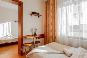 a bedroom with a bed and a mirror and a window at Natural Mielno in Mielno