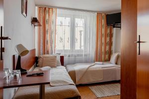 a hotel room with a bed and a window at Natural Mielno in Mielno