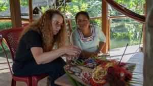 two women sitting at a table looking at something at Sinchi Warmi Amazon Lodge in Puerto Misahuallí +40 photos