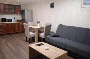 a living room with a couch and a table at Apartman Centar 1 in Šabac