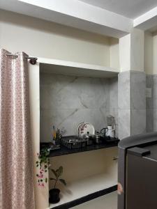 a kitchen with a sink and a counter top at Hazel's ELiTE Homestay 2bhk in Mysore +9 photos