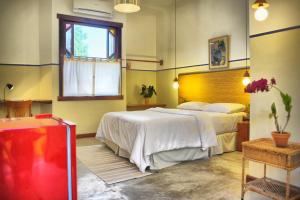 a bedroom with a large bed and a window at Pousada da Sesmaria in São Sebastião
