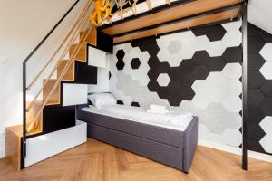 a bedroom with a bed and a staircase at Willa 27P Aura Kaszub in Łączyno +28 photos