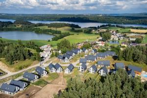 an aerial view of a village with a lake at Willa 27P Aura Kaszub in Łączyno