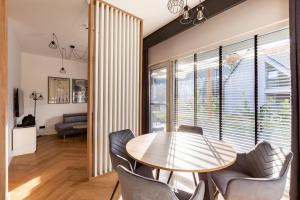 a dining room with a table and chairs at Willa 27P Aura Kaszub in Łączyno