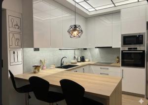 a kitchen with a wooden table and black chairs at Anna's sea view apartment in Kánithos