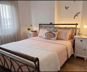 a bedroom with a large bed with two night stands at Anna's sea view apartment in Kánithos