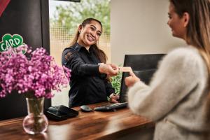 a woman standing at a table in front of a woman at Smarthotel Forus in Stavanger