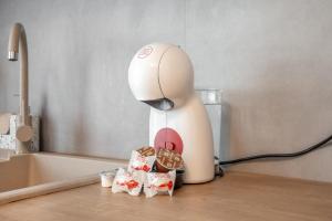 a hello kitty hair dryer sitting on a counter with cookies at XTN Chill House Aeroport with parking in Cluj-Napoca