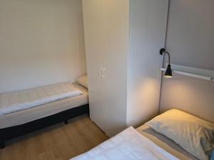 a small room with two beds and a closet at ZON Bed by the Sea in Westkapelle