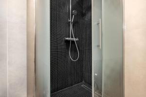 a shower with a glass door in a bathroom at XTN Chill House Aeroport with parking in Cluj-Napoca