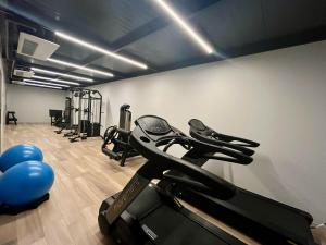 a gym with a treadmill and some exercise bikes at Edition 201- Flat aconchegante no Cabo Branco - ASKA in João Pessoa