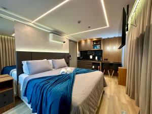 a bedroom with a large bed and a kitchen at Edition 201- Flat aconchegante no Cabo Branco - ASKA in João Pessoa +69 photos