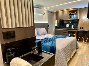 a hotel room with a bed and a sink at Edition 201- Flat aconchegante no Cabo Branco - ASKA in João Pessoa
