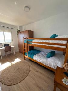 a bedroom with two bunk beds in a room at Ikigai Home in La Rábita
