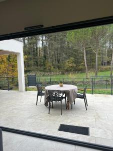 a table and chairs sitting on a patio at Villa les pins in Chambonas