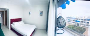 a hospital room with a bed and a window at Sea & Pool View Apt 1 in Aourir +24 photos