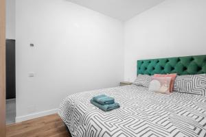 a bedroom with a large bed with a green headboard at XTN Chill House Aeroport with parking in Cluj-Napoca