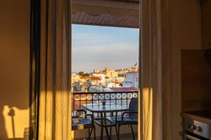 a view from a balcony with a table and chairs at Atticview Oropos in Néa Palátia