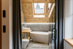 a bathroom with a tub and a sink at Veres Hill in Tukhlya